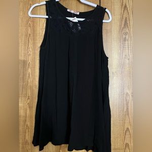 Large black sleeveless blouse with lace deta and open back detail